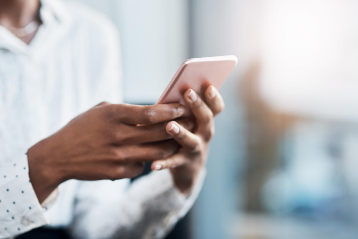 Woman using her phone. (Getty Images)