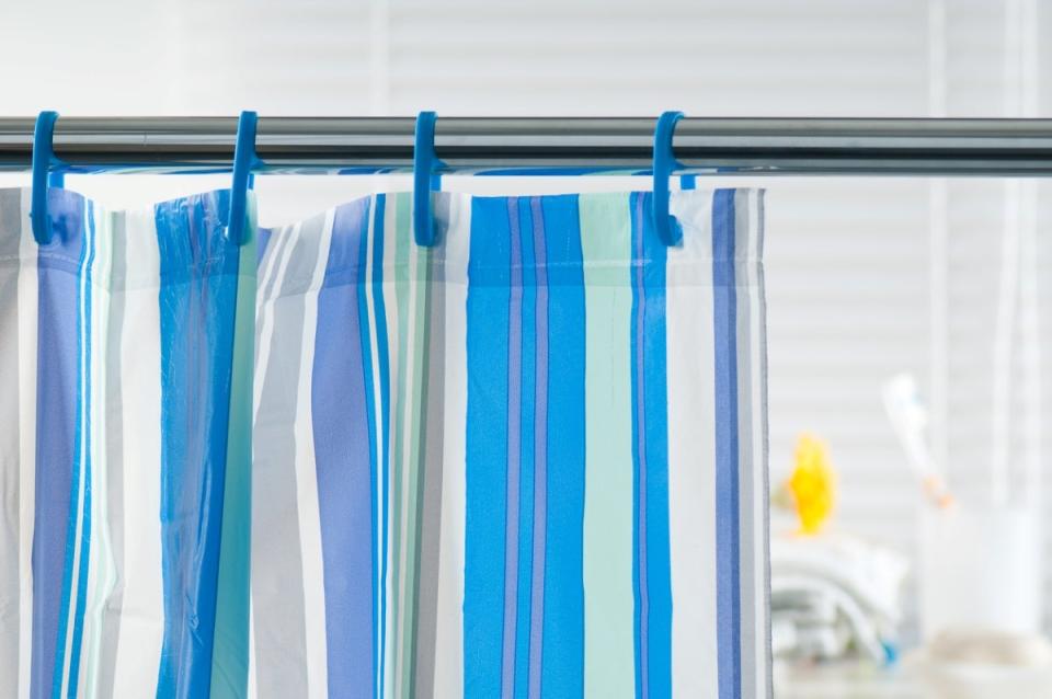 Shower curtain with blue striped pattern