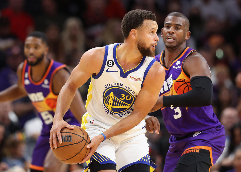 PHOENIX, ARIZONA - OCTOBER 25: Stephen Curry #30 of the Golden State Warriors handles the ball against Chris Paul #3 of the Phoenix Suns during the second half of the NBA game at Footprint Center on October 25, 2022 in Phoenix, Arizona. The Suns defeated the Warriors 134-105. NOTE TO USER: User expressly acknowledges and agrees that, by downloading and or using this photograph, User is consenting to the terms and conditions of the Getty Images License Agreement.  (Photo by Christian Petersen/Getty Images)