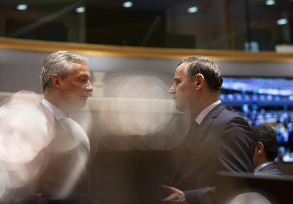 French Finance Minister Bruno Le Maire, left, speaks with Slovenian Finance Minister Andrej Bertoncelj during a meeting of EU finance ministers at the Europa building in Brussels, Tuesday, Feb. 18, 2020. EU finance ministers meet Tuesday to discuss tax havens. (AP Photo/Virginia Mayo)