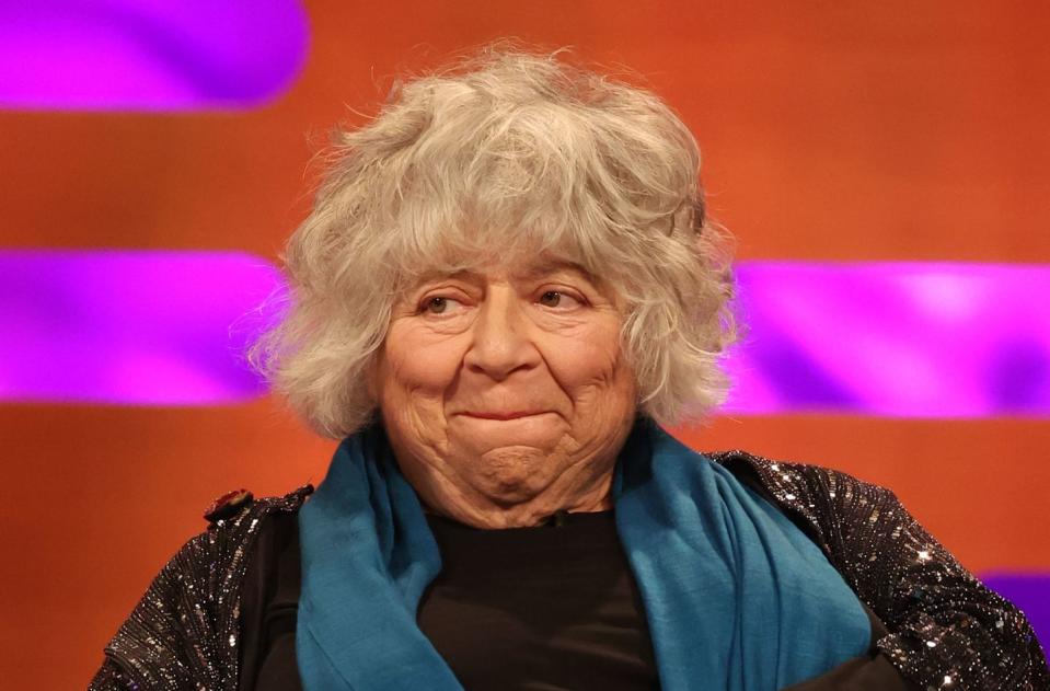 miriam margolyes on the graham norton show, an older woman bites her lip on a chat show