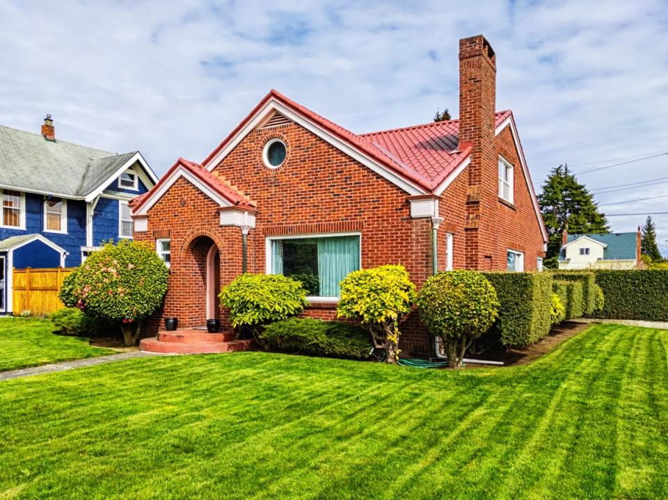 Older brick house with tidy lawn