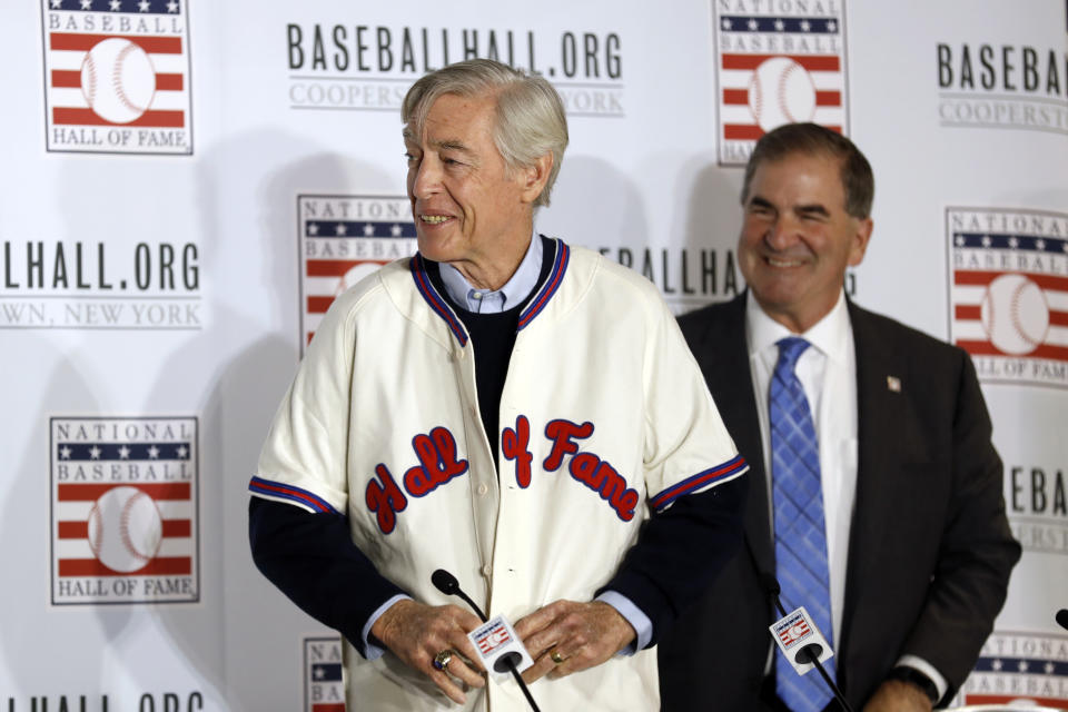 Former St. Louis Cardinals catcher Ted Simmons buttons a Hall of Fame jersey as National Baseball Hall of Fame President Tim Mead looks on, right, during the Major League Baseball winter meetings Monday, Dec. 9, 2019, in San Diego. Simmons was elected into the Hall of Fame Sunday. (AP Photo/Gregory Bull)