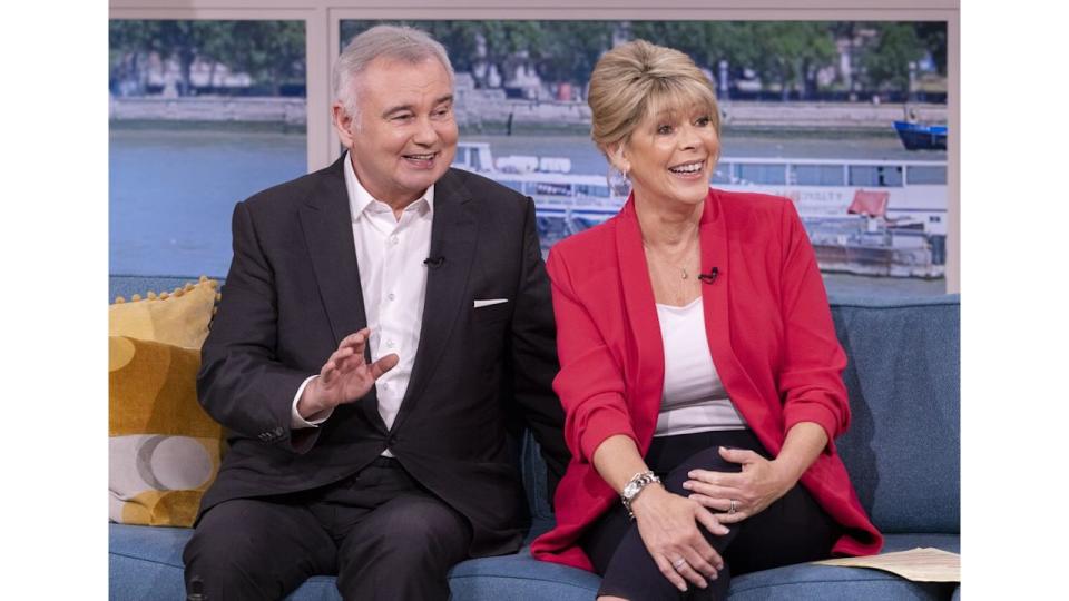 Eamonn Holmes in black suit and Ruth Langsford in red blazer on set of This Morning