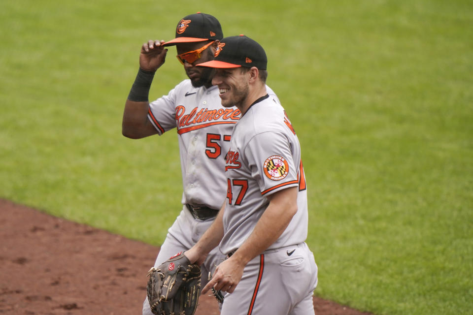 Baltimore Orioles starting pitcher John Means, right, smiles as he heads to the dugout with second baseman Hanser Alberto (57) after the first inning of a baseball game against the New York Yankees, Sunday, Sept. 13, 2020, at Yankee Stadium in New York. (AP Photo/Kathy Willens)