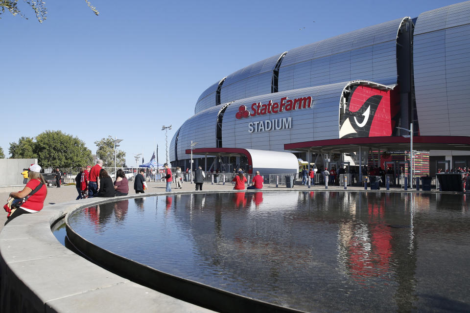 FILE - In this Thursday, Oct. 31, 2019, file photo, fans arrive prior to an NFL football game between the Arizona Cardinals and the San Francisco 49ers, in Glendale, Ariz. The San Francisco 49ers are set to embark on an unusual three-week road trip after being kicked out of their stadium and practice facility because of strict new COVID-19 protocols in their home county in Northern California. The Niners will fly to Arizona, where they will practice, live and play their next two games after Santa Clara County imposed a three-week ban on games and practices for contact sports. (AP Photo/Rick Scuteri, File)