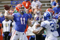 Florida quarterback Kyle Trask (11) throws a pass as Kentucky linebacker Jamar Watson (31) rushes during the first half of an NCAA college football game, Saturday, Nov. 28, 2020, in Gainesville, Fla. (AP Photo/John Raoux)