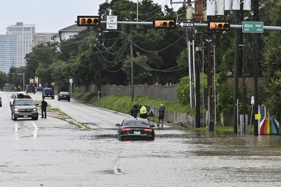 A vehicle is stranded in high waters on a flooded Allen Parkway in Houston, on Monday, July 8, 2024, after Beryl came ashore in Texas as a hurricane and dumped heavy rains downtown. (AP Photo/Maria Lysaker)