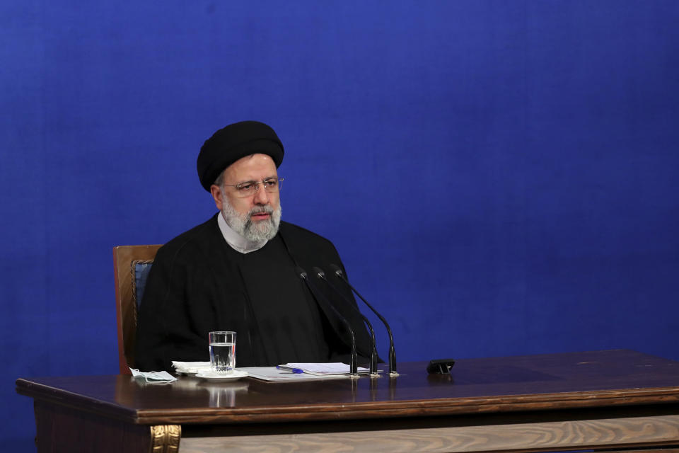 In this photo released by the official website of the office of the Iranian Presidency, President Ebrahim Raisi sits during his press conference in Tehran, Iran, Monday, Aug. 29, 2022. Raisi warned that any roadmap to restore Tehran's tattered nuclear deal with world powers must see international inspectors end their probe on man-made uranium particles found at undeclared sites in the country. (Iranian Presidency Office via AP)