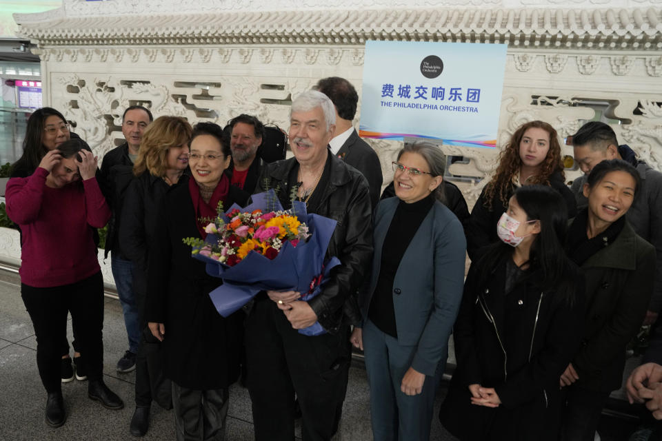 Philadelphia Orchestra's 73-year-old violinist Davyd Booth, center, stands with Shari Bistransky, Counselor for Public Affairs of the United States Embassy to China, and other members for photos at the Beijing Capital International Airport on Tuesday, Nov. 7, 2023. Musicians from the Philadelphia Orchestra arrived in Beijing on Tuesday, launching a tour commemorating its historic performance in China half a century ago in signs of improving bilateral ties ahead of a highly anticipated meeting between President Joe Biden and Xi Jinping. (AP Photo/Ng Han Guan)