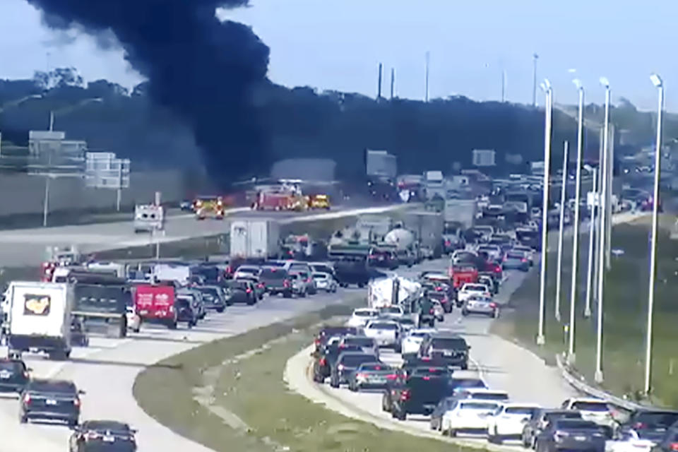 In this image provided by the Florida Department of Transportation, Florida Highway Patrol troopers are on the scene of a small airplane landing on southbound Interstate 75 in Naples, Fla., Friday, Feb. 9, 2024. The plane collided with a vehicle as it made the emergency landing. (Florida DOT/The News-Press via AP)