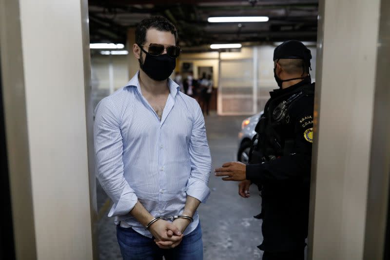 Luis Enrique, one of the sons of former Panamanian President Ricardo Martinelli, is escorted by police officers after being detained along with his brother Ricardo to face extradition to the U.S. on money laundering charges, in Guatemala City