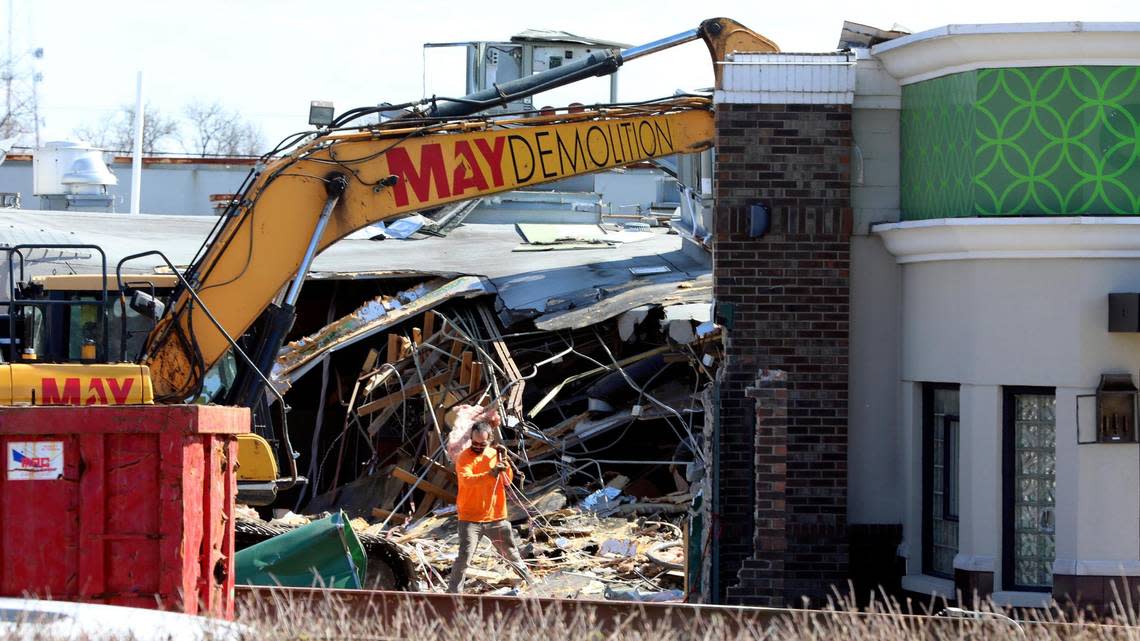 A demo contractor with May Demolition clears a cable at the site of the former O’Charley’s location at 2895 Richmond Road, which is being torn down Monday, March 27, 2023. The chain restaurant closed in 2020 and had been empty since.