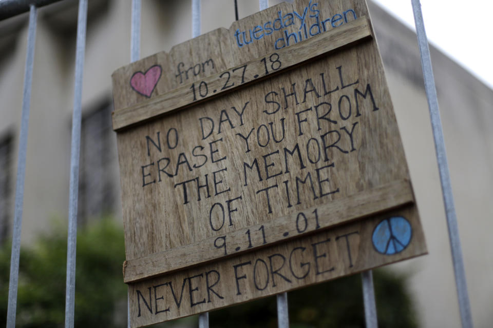 A sign hangs on a fence surrounding the Tree of Life synagogue in Pittsburgh, on Saturday, Oct. 26, 2019. The first anniversary of the shooting at the synagogue that killed 11 worshippers and injured others is on Sunday, Oct., 27, 2019. (AP Photo/Gene J. Puskar)