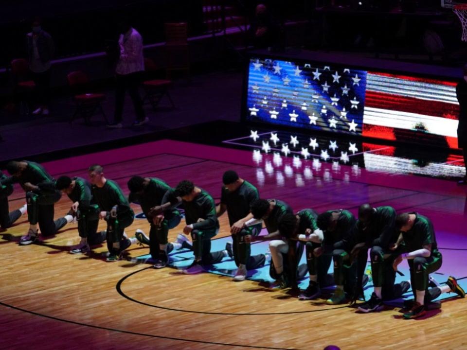 Players from the Boston Celtics kneel for the national anthem (USA TODAY Sports)