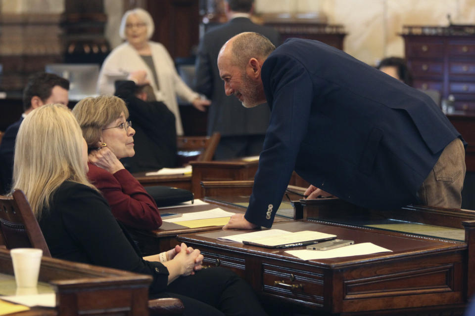 Kansas state Sen. Mark Steffen, right, R-Hutchinson, confers with Sen. Beverly Gossage, R-Eudora, left, during the Senate's session, Wednesday, Feb. 7, 2024, at the Statehouse in Topeka, Kan. All three senators wanted to force a debate on a proposed 93% pay raise for legislators starting next year but that effort has failed, and the pay raise is set to take effect. (AP Photo/John Hanna)