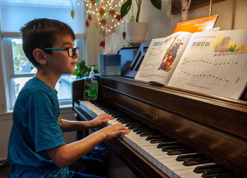 Wesley Adamec, 8, of Ashland, practices piano during a recent visit to Centre House Music in Framingham, Oct. 13, 2023.