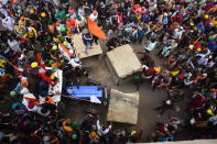 DELHI, INDIA - 2021/01/26: Protesters remove police barricades from the road during the demonstration. Farmers protesting against agricultural reforms breached barricades and clashed with police in the capital on the India's 72nd Republic Day. The police fired tear gas to restrain them, shortly after a convoy of tractors trundled through the Delhi's outskirts. (Photo by Manish Rajput/SOPA Images/LightRocket via Getty Images)