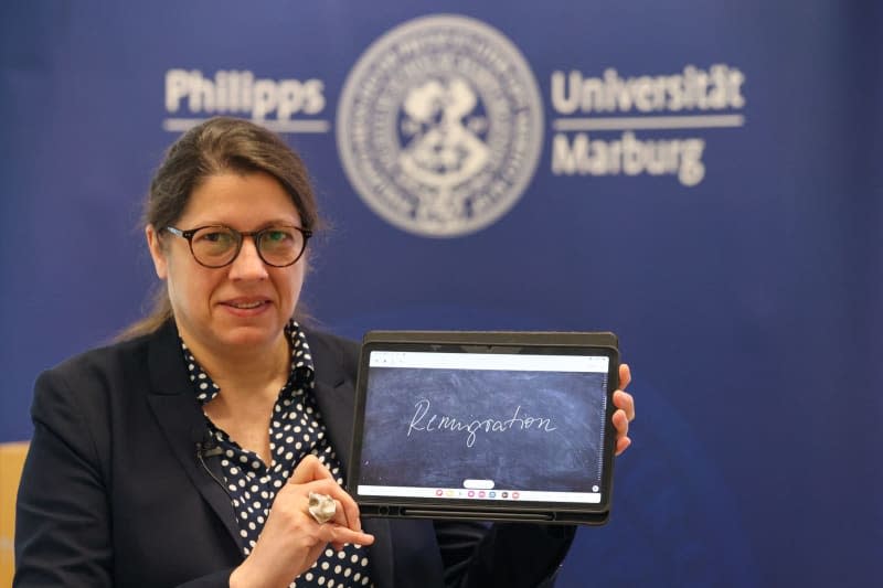 Constanze Spiess, linguist at Philipps University Marburg and jury spokesperson, presents the term "remigration" on a tablet. The "Unword of the Year" 2023 in Germany is "Remigration". onday. Nadine Weigel/dpa