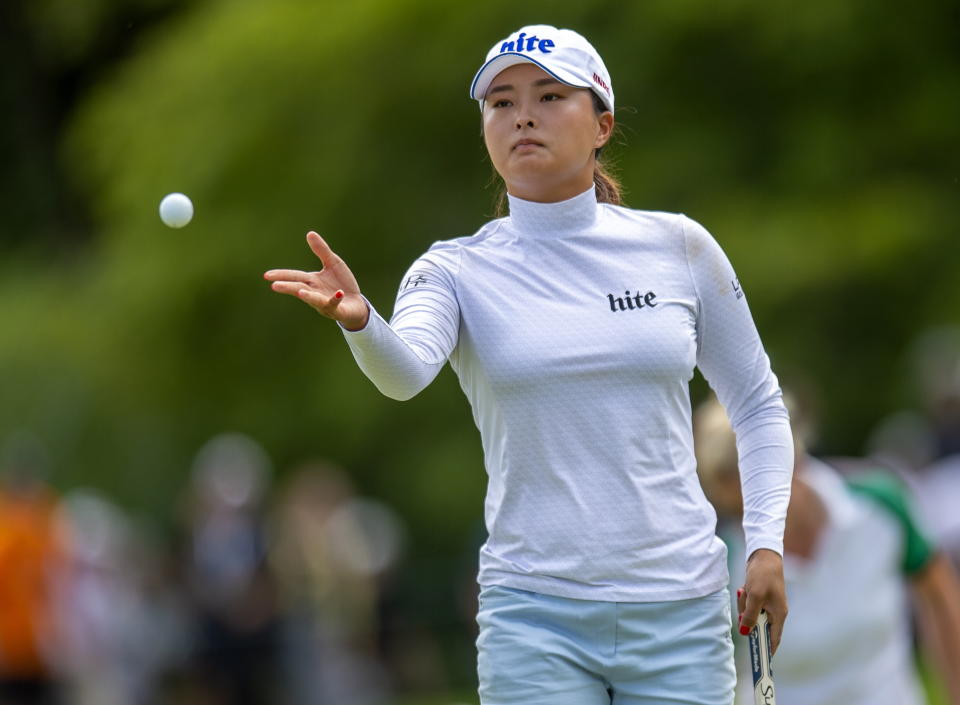 Jin Young Ko, of South Korea, tosses a golf ball to her caddie on the first green during the third round of the CP Women's Open in Aurora, Ontario, Canada, Saturday, Aug. 24, 2019. (Frank Gunn/The Canadian Press via AP)