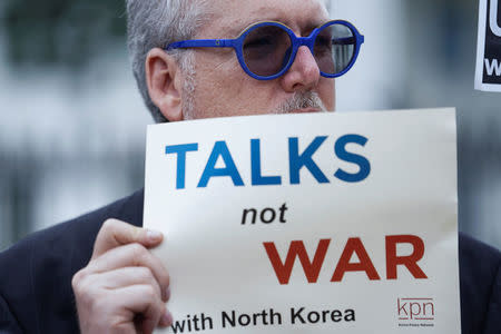 Activists hold a vigil outside the White House to celebrate the joint summit between U.S. President Donald Trump and North Korean leader Kim Jong Un held in Singapore, in Washington, U.S., June 11, 2018. REUTERS/Toya Sarno Jordan