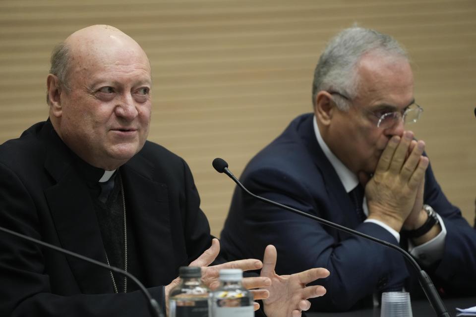 Cardinal Gianfranco Ravasi, left, flanked by Lazio President Claudio Lotitio, talks to journalists as he presents the soccer match between the Vatican soccer team "Fratelli Tutti" (All Brothers) and the World Rom Organization team, at the Vatican, Tuesday, Nov. 16, 2021. The match will be played Sunday, Nov. 21, at the Lazio training ground of Formello. (AP Photo/Gregorio Borgia)