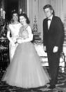 FILE - In this file photo dated June 5, 1961, Queen Elizabeth II, center, walks with U.S. President John F. Kennedy, right, and his wife Jacqueline Kennedy, as they enter an ante-room in Buckingham Palace, London, before a dinner given by the Queen in honour of the visiting President and his wife. (AP Photo, File)