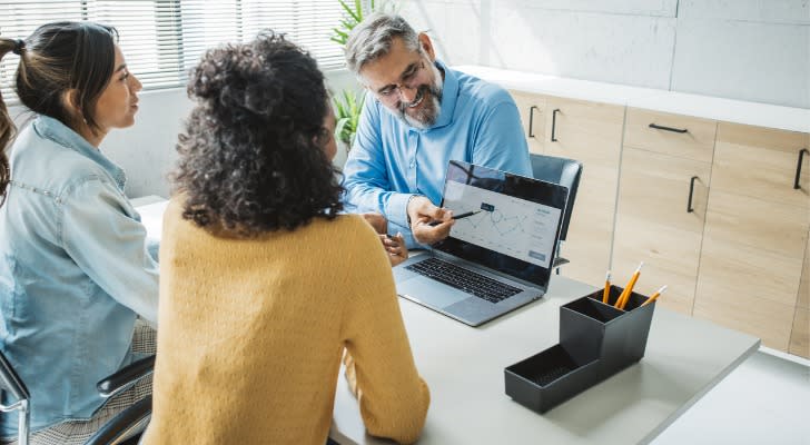 A financial advisor meets with a couple and goes over their comprehensive financial plan.