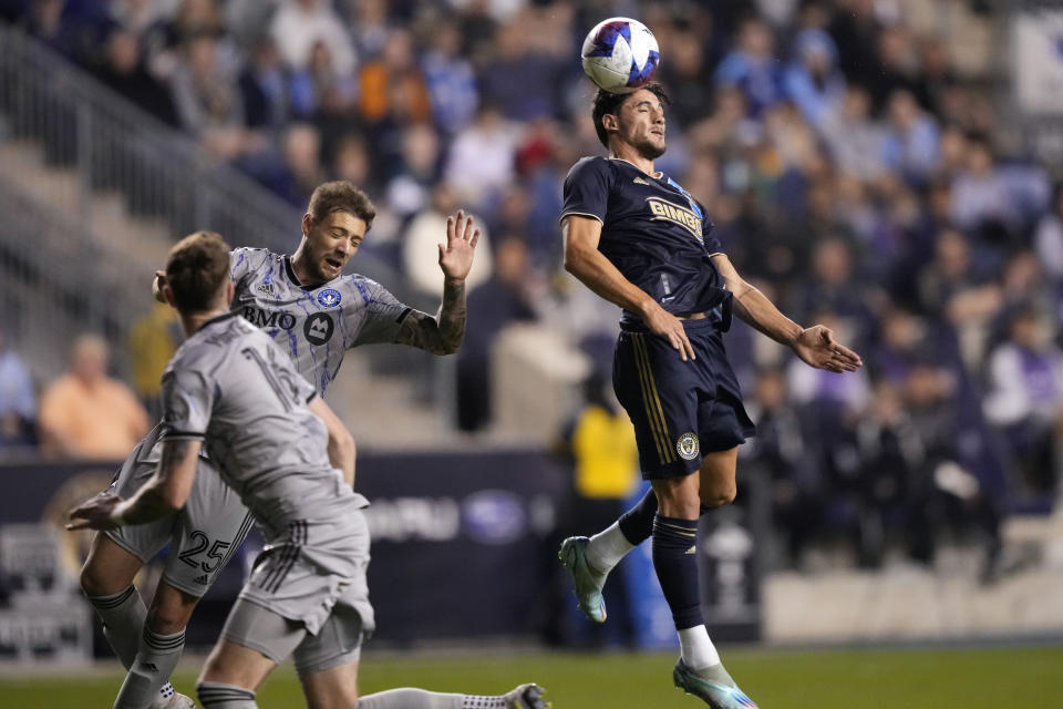 Philadelphia Union's Julián Carranza, right, leaps for the ball past CF Montréal's Gabriele Corbo, center, and Joel Waterman during the second half of an MLS soccer match, Saturday, June 3, 2023, in Chester, Pa. (AP Photo/Matt Slocum)