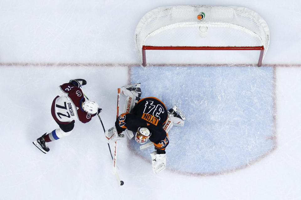 Philadelphia Flyers' Alex Lyon (34) blocks a shot by Colorado Avalanche's Joonas Donskoi (72) during the first period of an NHL hockey game, Saturday, Feb. 1, 2020, in Philadelphia. (AP Photo/Matt Slocum)