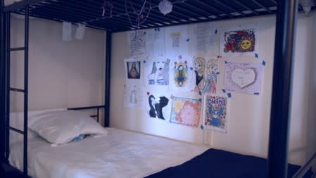 Artwork is seen over a bed at the HHS unaccompanied minors migrant detention facility at Carrizo Springs