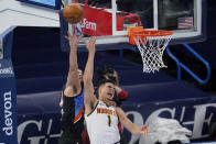 Oklahoma City Thunder guard Kenrich Williams, left, fouls Denver Nuggets forward Michael Porter Jr. (1) during the first half of an NBA basketball game Saturday, Feb. 27, 2021, in Oklahoma City. (AP Photo/Sue Ogrocki)