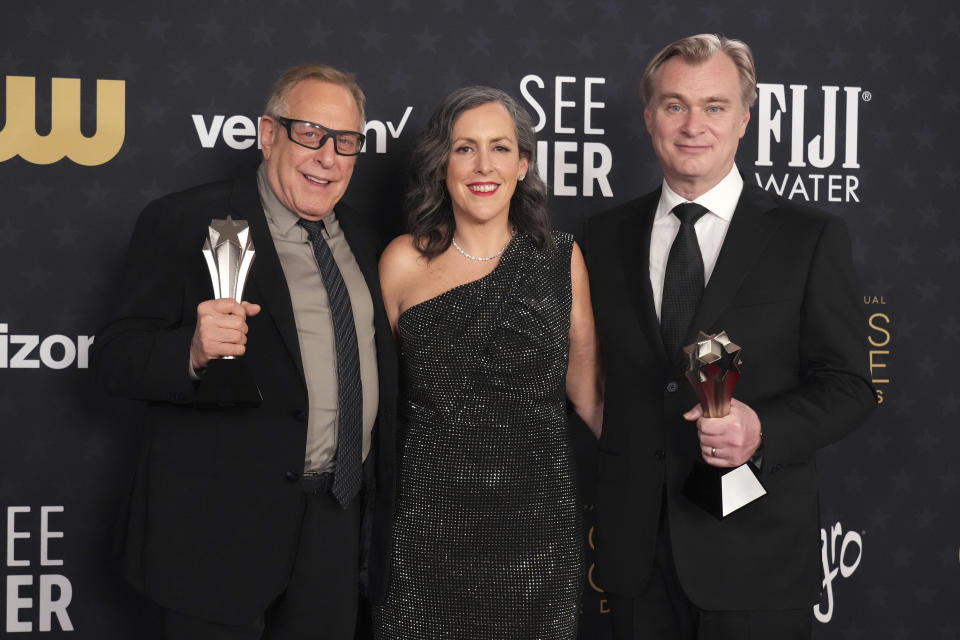 Charles Roven, from left, Emma Thomas, and Christopher Nolan pose in the press room the award for best picture for "Oppenheimer" during the 29th Critics Choice Awards on Sunday, Jan. 14, 2024, at the Barker Hangar in Santa Monica, Calif. (Photo by Jordan Strauss/Invision/AP)