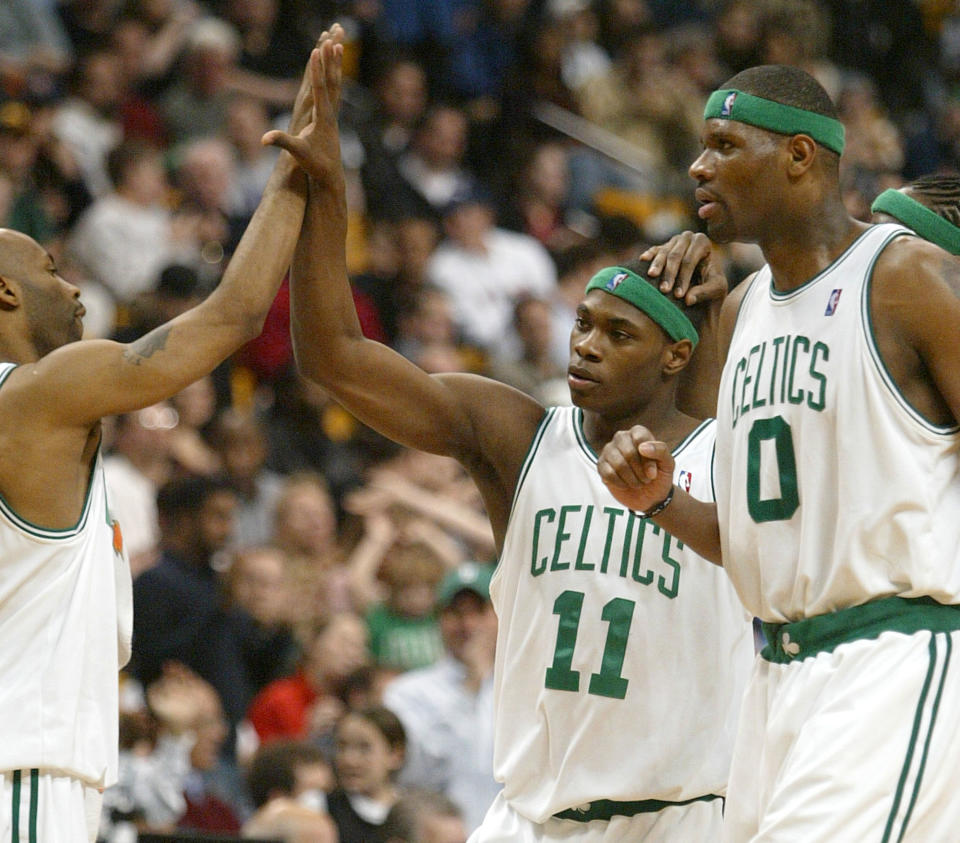 Boston Celtics’ Marcus Banks, center, is congratulated by teammates, Chucky Atkins, left, and Walter Mc Carty, right, after Banks forced a key turnover against the <a class="link " href="https://sports.yahoo.com/nba/teams/golden-state/" data-i13n="sec:content-canvas;subsec:anchor_text;elm:context_link" data-ylk="slk:Golden State Warriors;sec:content-canvas;subsec:anchor_text;elm:context_link;itc:0">Golden State Warriors</a> during the fourth quarter at the Fleet Center, Friday, April 2, 2004, in Boston. The Celtics won the game, 111-106. (AP Photo/Jim Rogash)