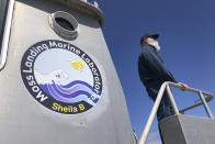 Scott Benson, an ecologist and leatherback turtle expert with the National Oceanic and Atmospheric Administration Fisheries Service, based in Moss Landing looks out over the water from his research boat in Monterey, Calif., on March 25, 2021. Benson has studied western Pacific leatherback turtles for decades and recently co-authored a study that shows an 80% population drop in just 30 years for one extraordinary sub-group that migrates 7,000 miles across the Pacific Ocean to feed on jellyfish in cold waters off California. (AP Photo/Haven Daley)