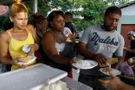 Cuban migrants receive their meals during lunch time at a temporary shelter in a school in the town of La Cruz, Costa Rica, near the border with Nicaragua, November 16, 2015. More than a thousand Cuban migrants hoping to make it to the United States were stranded in the border town of Penas Blancas, Costa Rica, on Monday after Nicaragua closed its border on November 15, 2015 stoking diplomatic tensions over a growing wave of migrants making the journey north from the Caribbean island. REUTERS/Juan Carlos Ulate