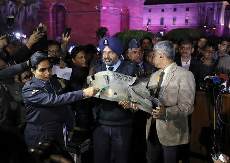 Indian Air Force officials display a wreckage of AMRAAM air-to-air missile that they say was fired by Pakistan Air Force fighter jet during a strike over Kashmir on Wednesday, after speaking with the media in the lawns of India's Defence Ministry in New Delhi, India, February 28, 2019. REUTERS/Anushree Fadnavis