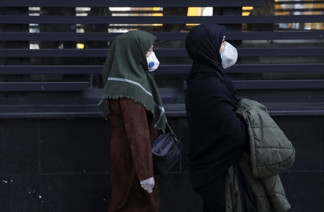 People wear masks in central Tehran