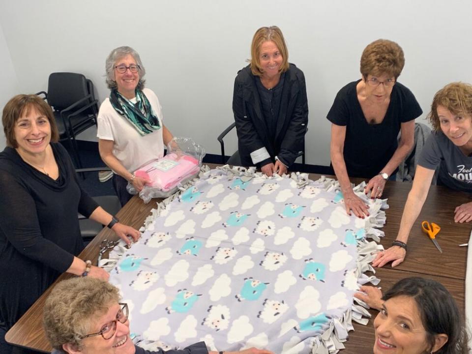 Volunteers at the National Council of Jewish Women/Cleveland assembling a fleece blanket | National Council of Jewish Women/Cleveland