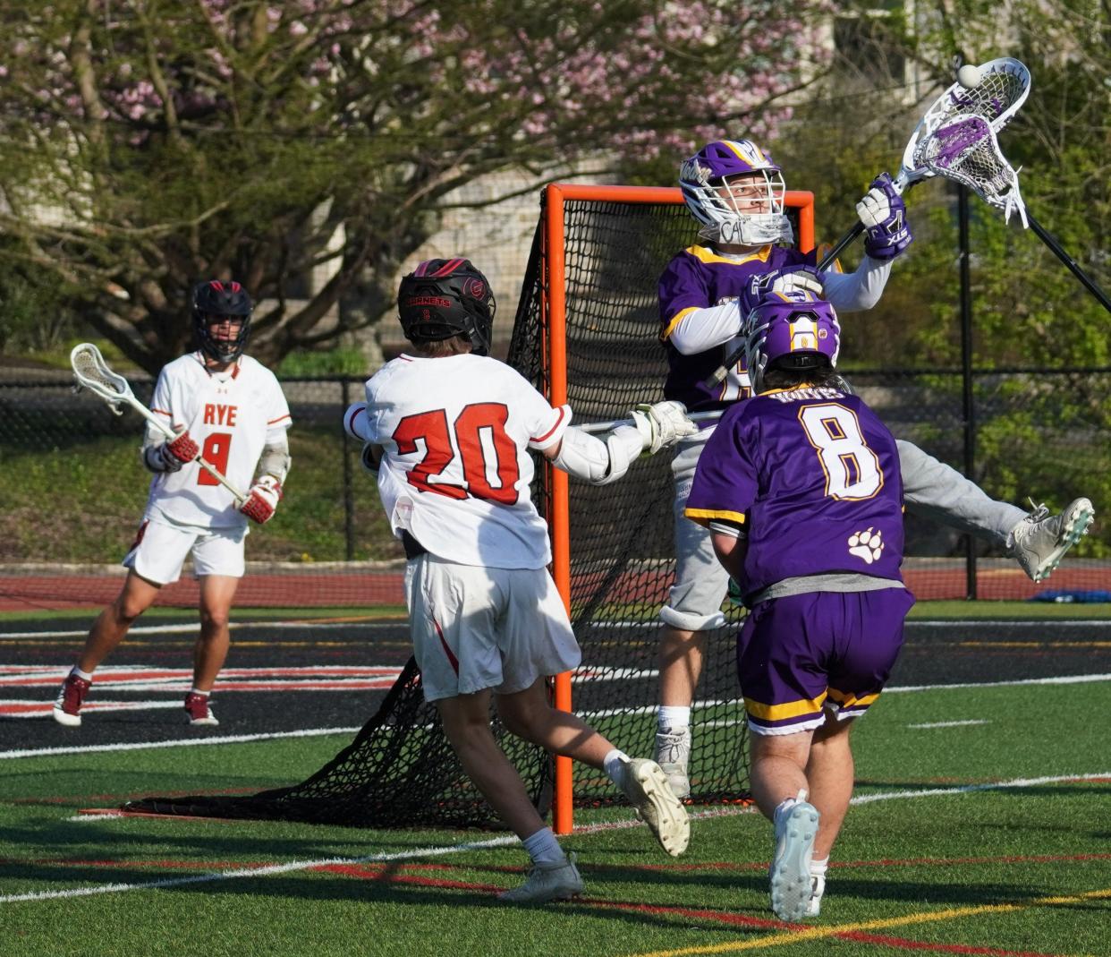 John Jay goalie Blake O'Callaghan gains control of the ball after stopping a point-blank shot from Rye attackman Garrett O'Sullivan. The Garnets went on to win 10-4 at Nugent Field on April 20, 2023.