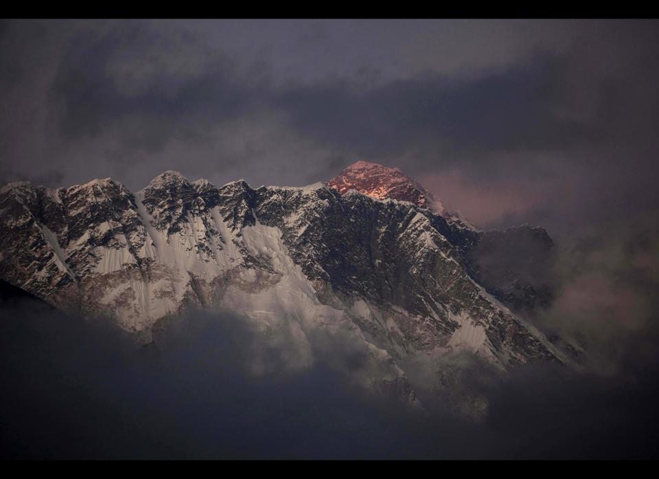 In this Oct. 27, 2011 file photo, the last light of the day sets on Mount Everest as it rises behind Mount Nuptse as seen from Tengboche, in the Himalaya's Khumbu region, Nepal. (AP Photo/Kevin Frayer, File)