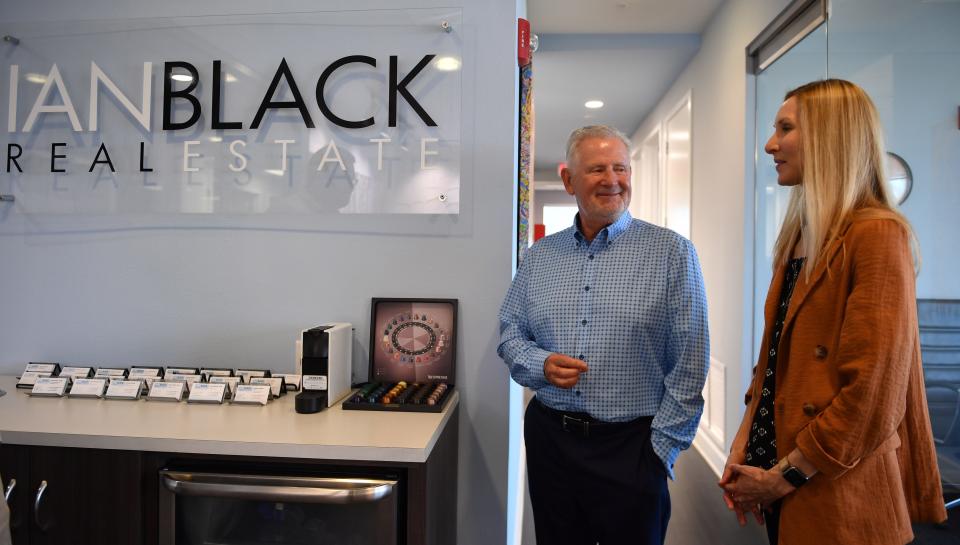 Commercial real estate broker Ian Black, talks with business partner Marci Marsh, in their downtown Sarasota office.