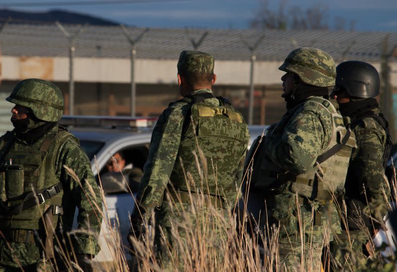 Members of the Mexican National Guard stand guard as they keep watch outside the prison after sixteen inmates were killed and five were wounded in a prison fight at the Regional Center for Social Reintegration in the town of Cieneguillas