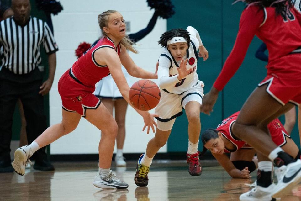 George Rogers Clark’s Kennedy Stamper, left, and Sacred Heart’s Amirah Jordan fight for the loose ball during their game on Feb. 9 at St. Xavier High School. Clare Grant/USA TODAY NETWORK