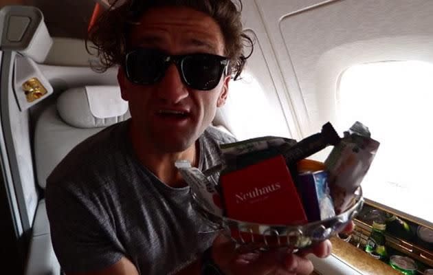 Casey takes us behind the first class curtain to all the snacks, drinks and leg space we've only dreamed about. Image: Youtube/CaseyNeistat