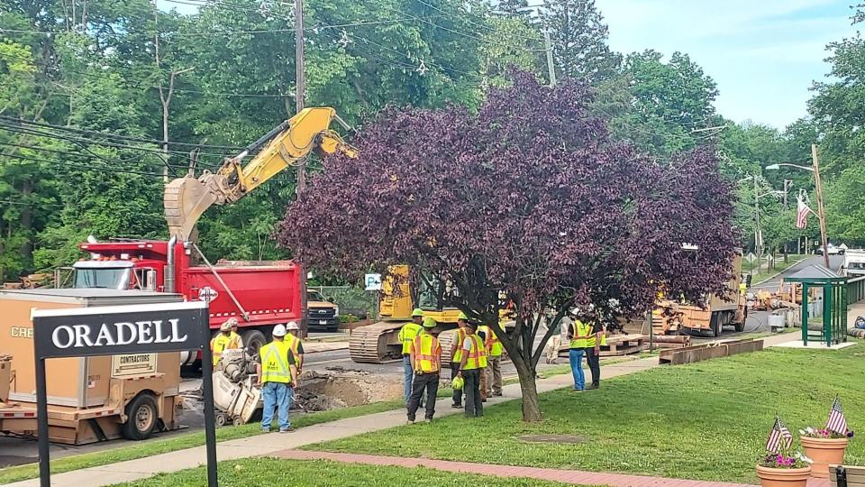 County crews work to repair a severed sewage line and resulting sinkhole on Oradell Avenue in Oradell, New Jersey, Monday, May 23, 2022.