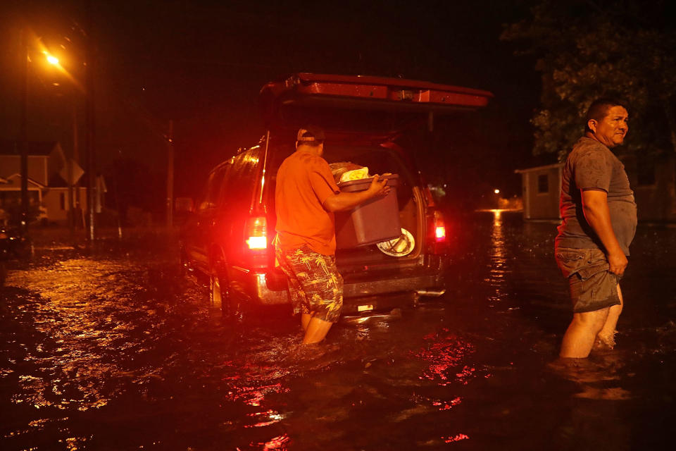 Men pack their belongings after evacuating their house after the Neuse River went over its banks and flooded their street during Hurricane Florence in New Bern, North Carolina, on Thursday.