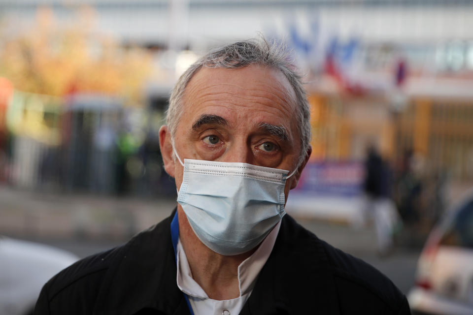 Dr. Philippe Montravers speaks with The Associated Press at the main entrance of the Bichat Hospital, in Paris on Tuesday, Nov. 10, 2020. Montravers and the 150 doctors and nurses he leads have become experts about how to treat COVID-19. That knowledge is proving invaluable against a second deadly surge of the virus is again threatening to overwhelm European health systems. (AP Photo/Francois Mori)