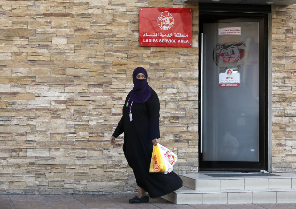 A woman leaves a ladies only service area at a restaurant in Jiddah, Saudi Arabia, Sunday, Dec. 8, 2019. Women in Saudi Arabia will no longer need to use separate entrances from single men or sit behind partitions at restaurants and cafes in the latest measure announced Sunday by the government that upends a major hallmark of the conservative restrictions that had been in place for decades. (AP Photo/Amr Nabil)