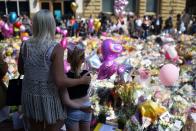 <p>People gather to see flowers and messages of support in St. Ann's Square in Manchester, northwest England, placed there in tribute to the victims of the May 22 terror attack at the Manchester Arena.</p>